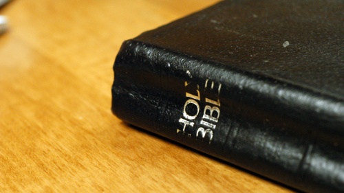 Bible laying on top of a table
